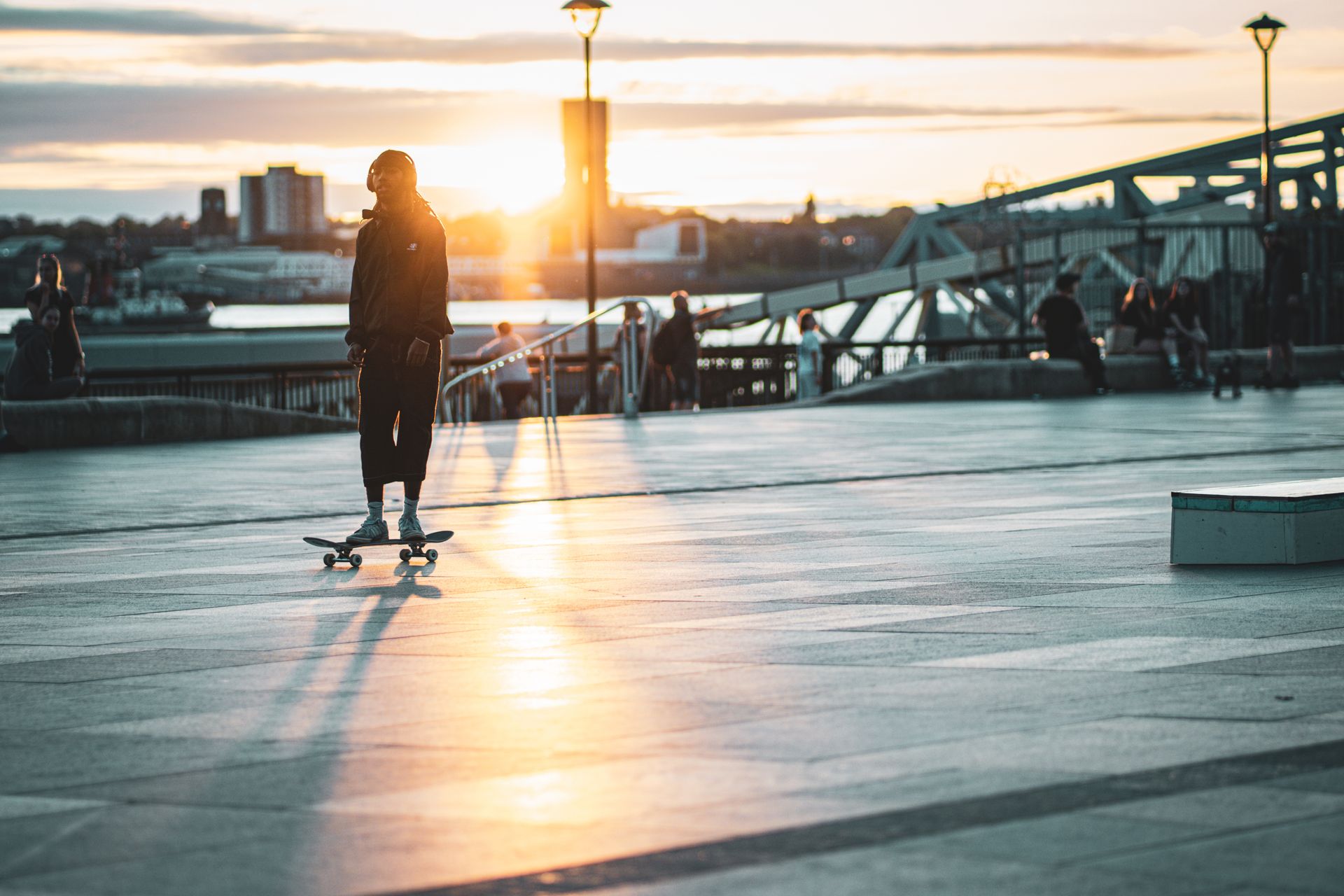 Skater riding through a city street at sunset